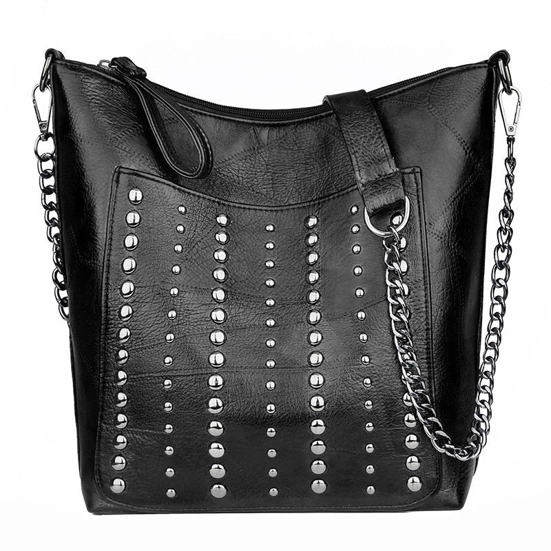 Vintage bucket shape handbag for women with rivets and chain strap, perfect for grunge outfits.