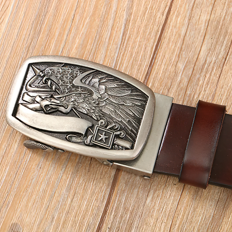 Vintage men's leather belt with eagle buckle, showcasing retro style details on wooden background.
