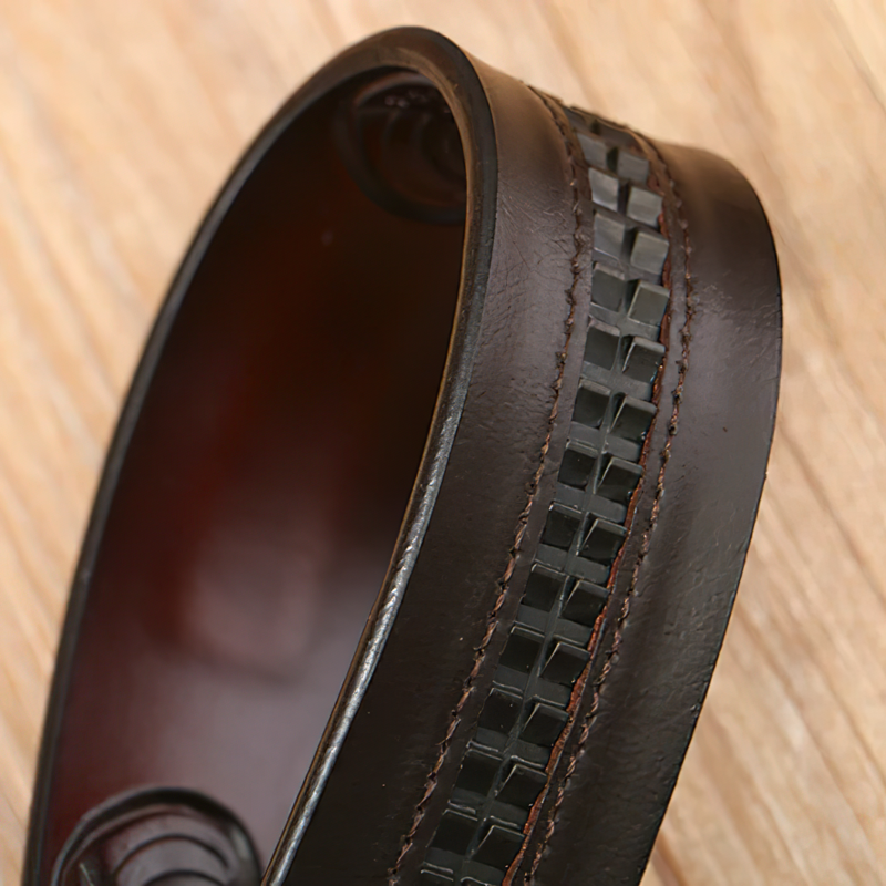 Close-up of a vintage men's leather cowboy belt with decorative stitching and unique textured design.