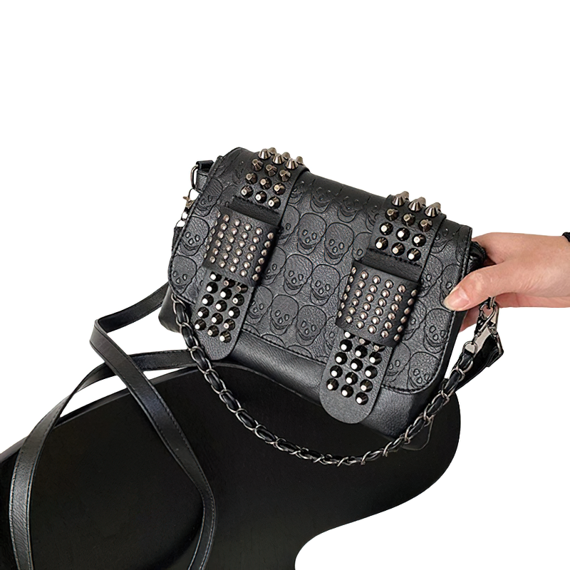 Vintage black crossbody bag with rivets, stylish PU leather accessory for women.