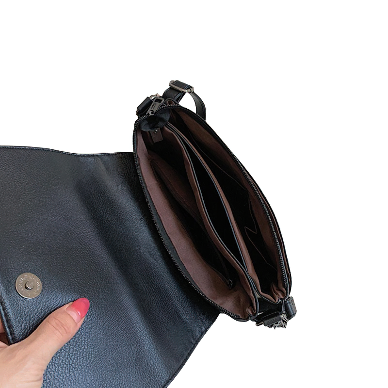Vintage women's crossbody bag with rivets, showcasing an open interior for stylish organization.