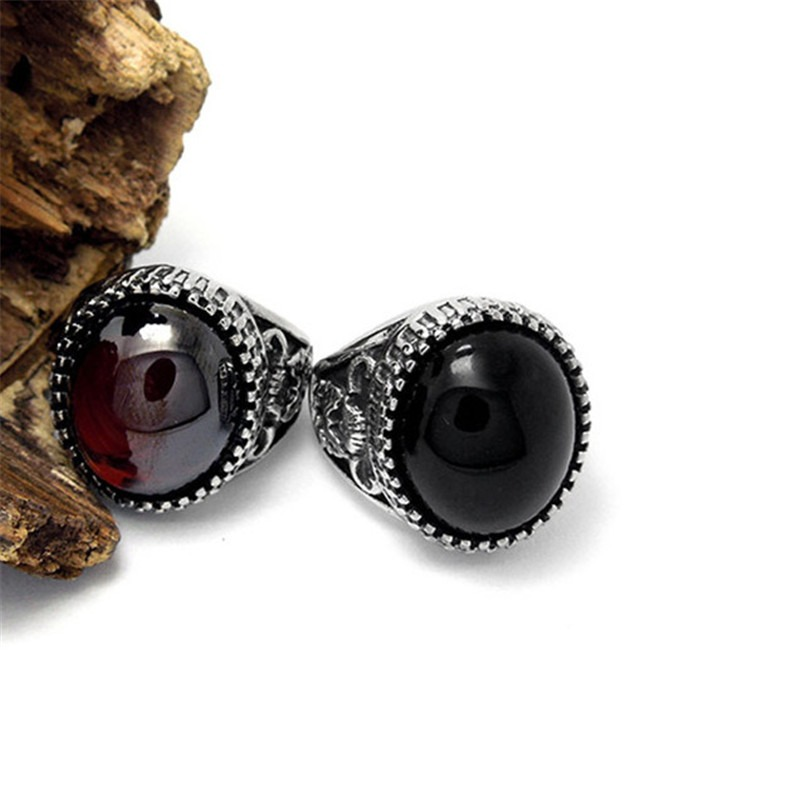 Vintage unisex stainless steel rings featuring large black and red stones, perfect for alternative fashion enthusiasts.