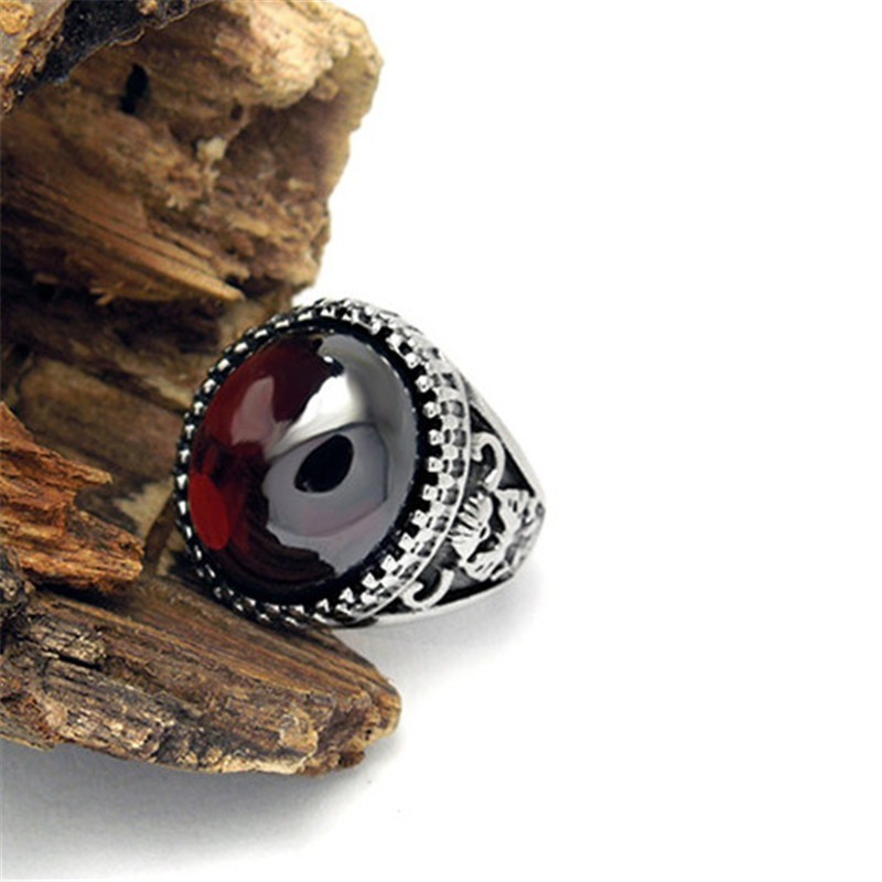 Vintage unisex stainless steel ring featuring a striking red stone, perfect for gifting or alternative fashion.
