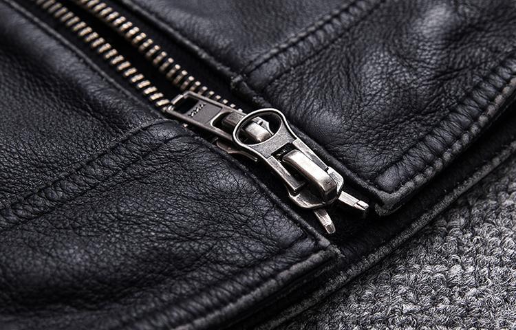 Close-up of a silver zipper on a black leather biker vest, showcasing stylish rock fashion details.