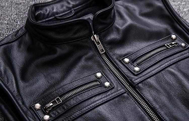Close-up of a black biker leather vest featuring zipped pockets, perfect for a vintage rock style.