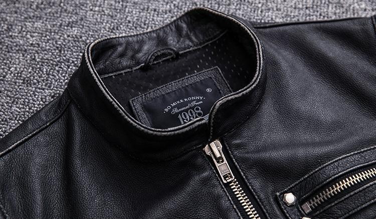 Close-up of the collar and zipper of a black biker leather vest with vintage style details.