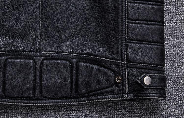 Close-up of a black biker leather vest showcasing textured leather and practical snaps for a vintage rock style.