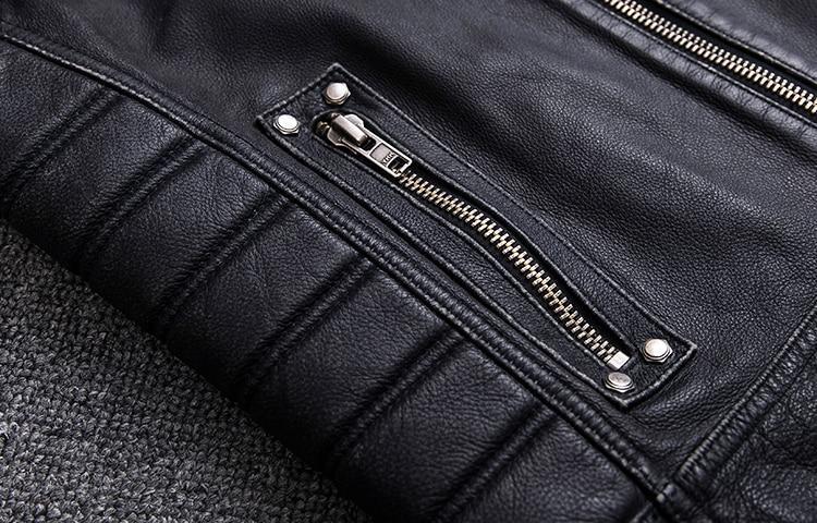Close-up of a black biker leather vest showcasing zipped pocket details and textured stitching.
