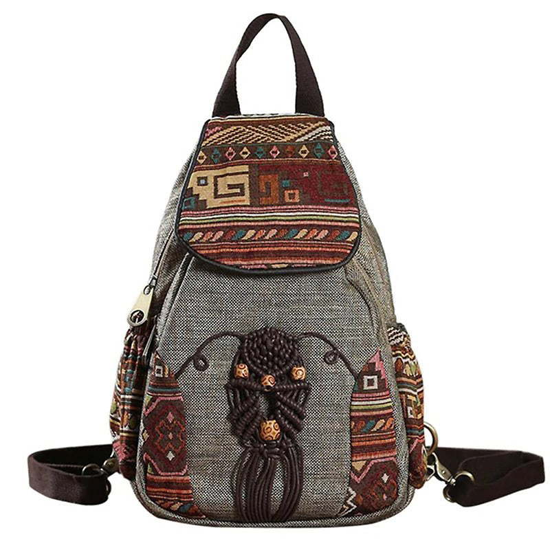 Vintage embroidered ethnic canvas backpack with intricate designs and spacious compartments for travel.