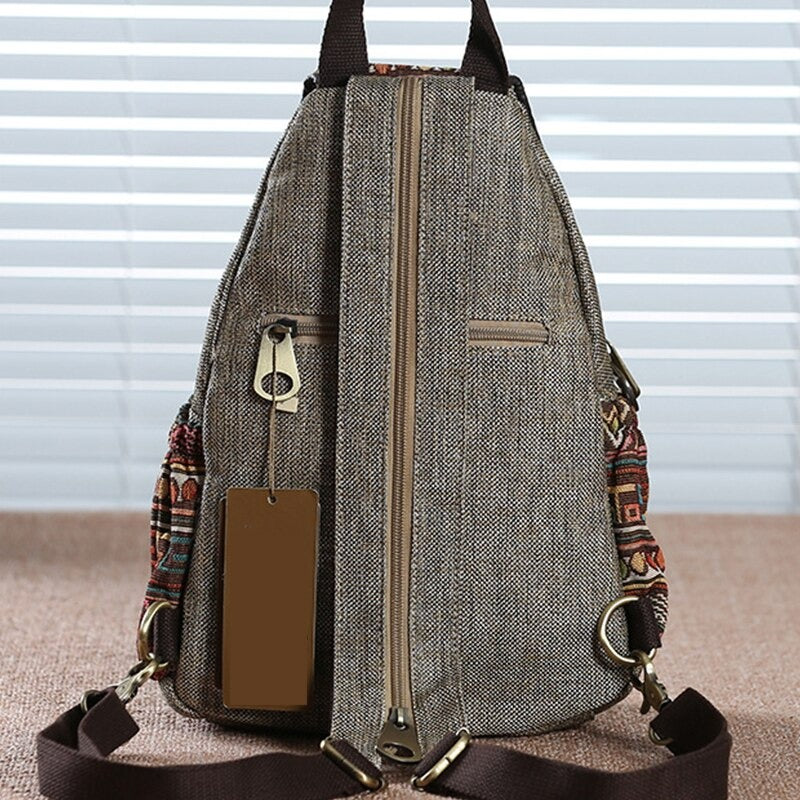 Vintage embroidered ethnic canvas backpack showing detailed stitching and sturdy zip for secure travel.