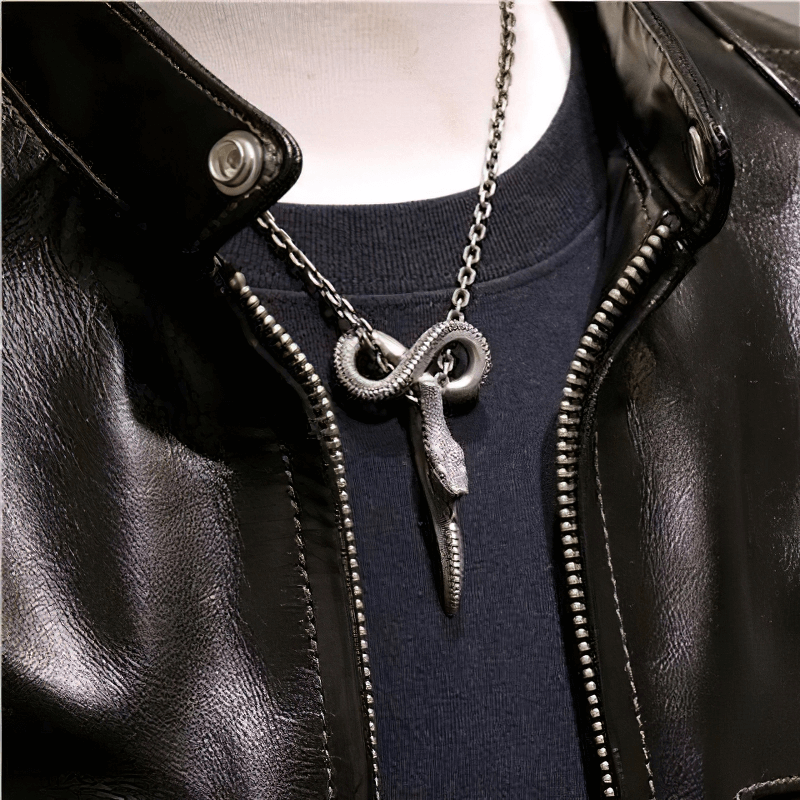 Vintage punk carving snake pendant on a silver chain, styled with a black leather jacket.