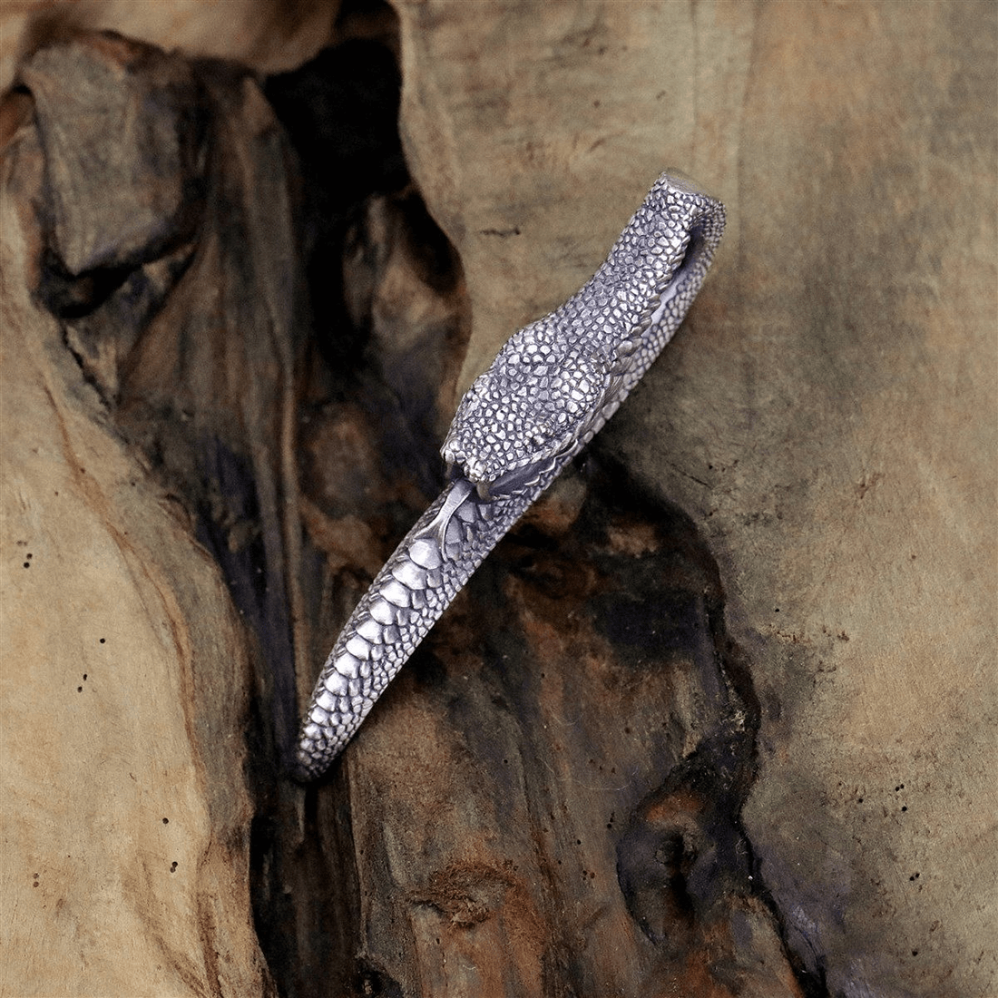 Vintage carving snake pendant on wood, a stylish punk jewelry piece for men and women.