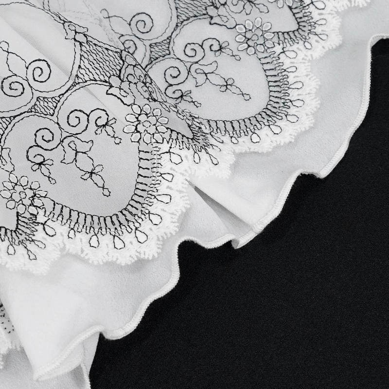 Close-up of delicate lace trim with embroidered heart designs on vintage flared gloves, perfect for gothic style outfits.