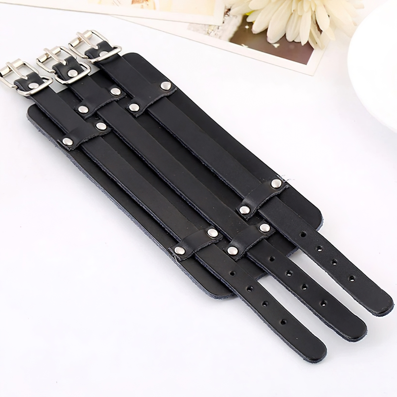 Vintage genuine leather cuff bracelet in punk style, showcasing a sleek black design with stylish buckles.