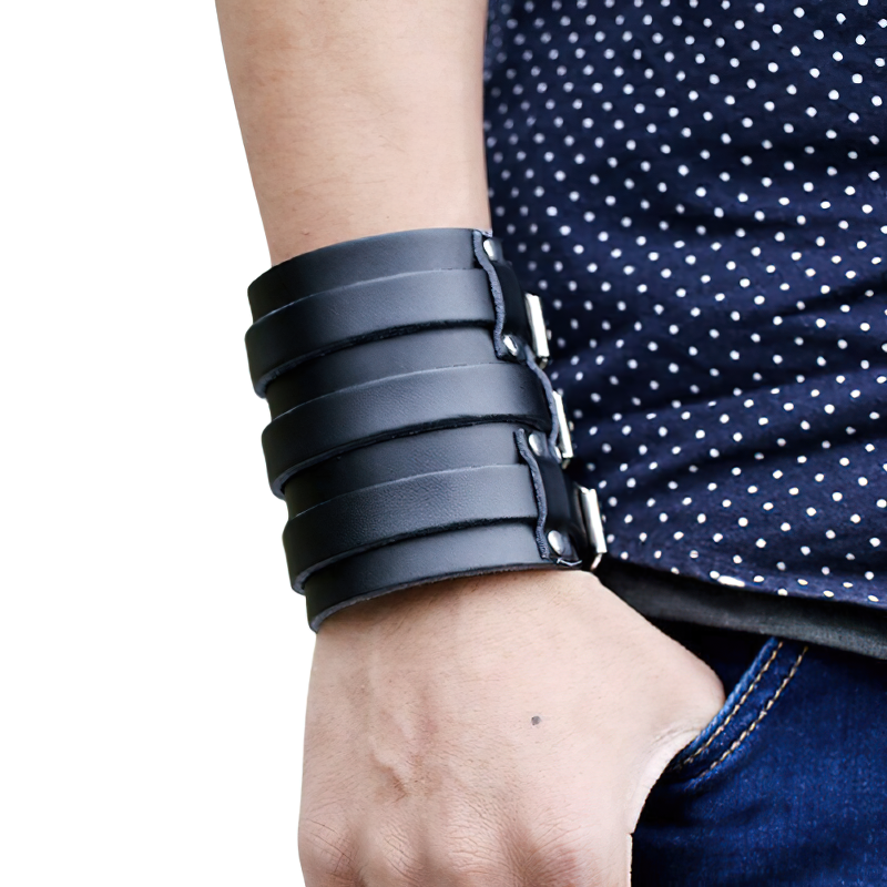 Vintage genuine leather punk style cuff bracelet worn on wrist, featuring a bold, layered design for a cool fashion statement.