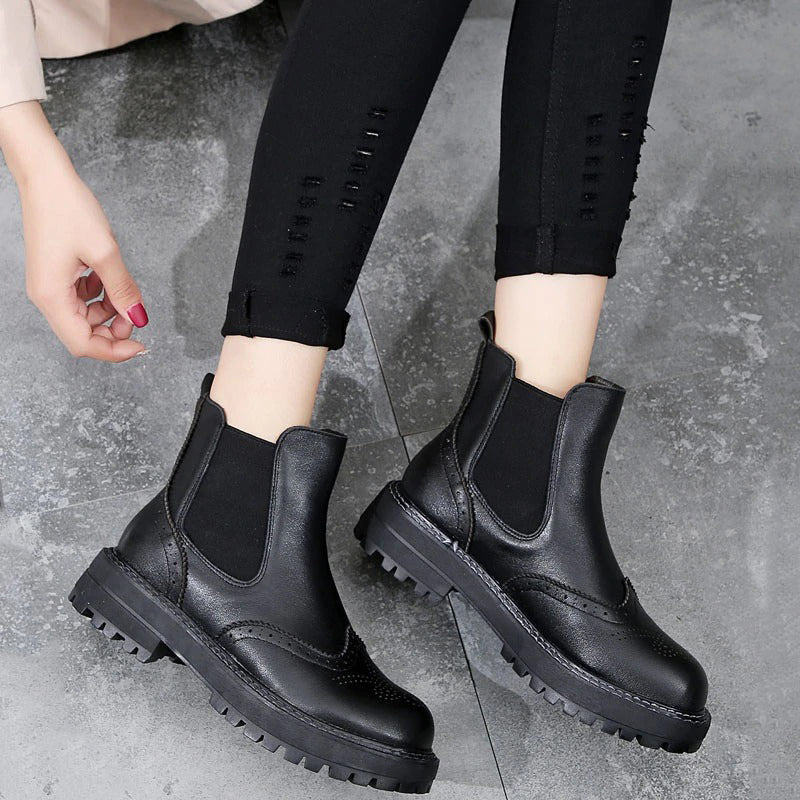 Vintage black leather flat ankle boots for ladies, perfect for spring, autumn, and winter streetwear looks.