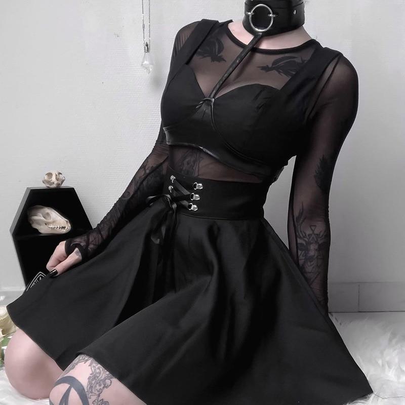 Model wearing a vintage gothic pleated skirt with lace-up and rivet details, perfect for punk grunge style.