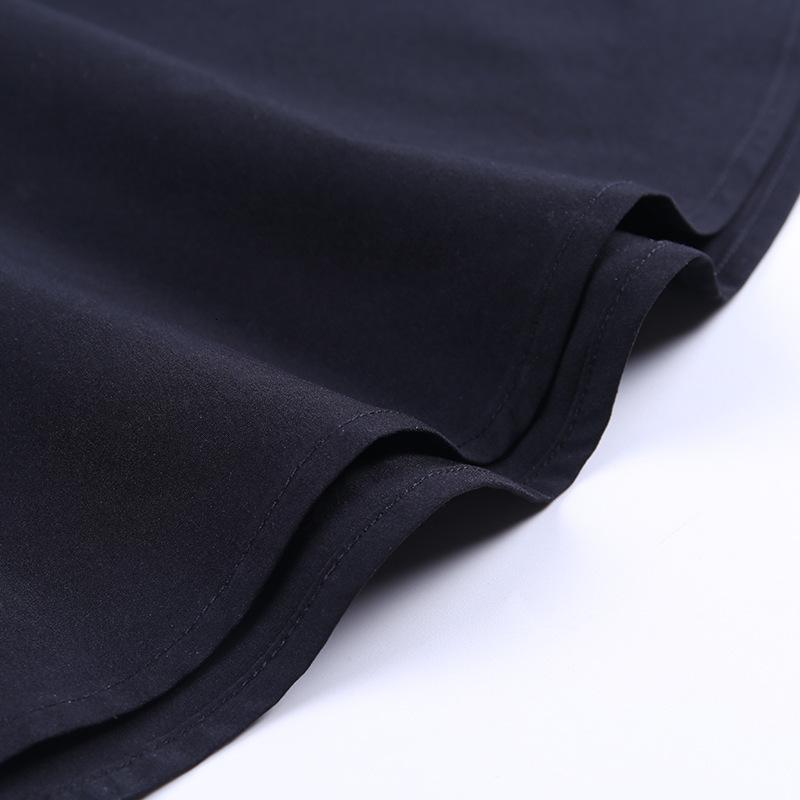 Close-up of the black fabric of a vintage gothic pleated skirt with smooth edges.