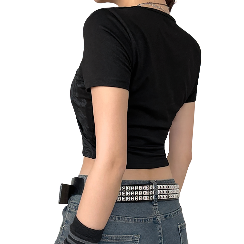 Woman wearing a black vintage grunge short sleeve crop top, highlighting a stylish and trendy design.