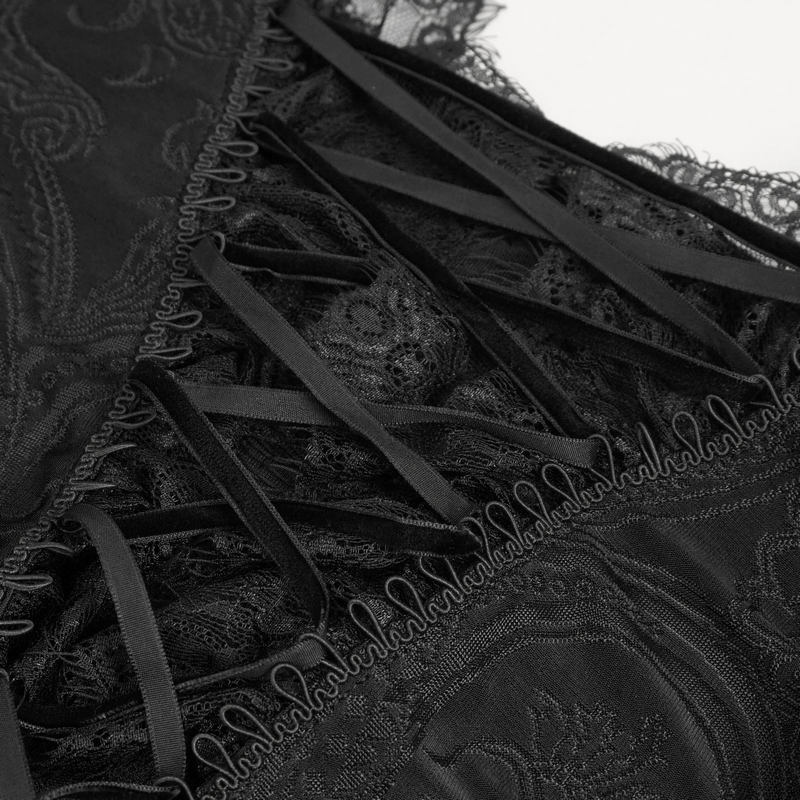 Close-up of vintage black top showcasing flared lace sleeves and lace-up front detail.