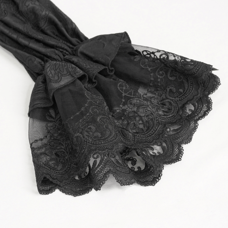 Close-up of flared lace sleeve detail from a vintage black top, showcasing intricate lace patterns.