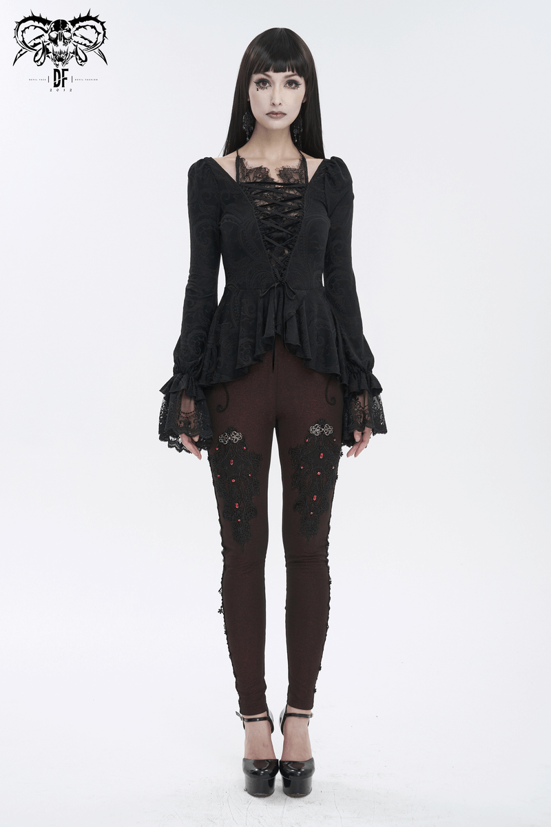 Model wearing a vintage black top with flared lace sleeves and lace-up front, paired with stylish embellished leggings.