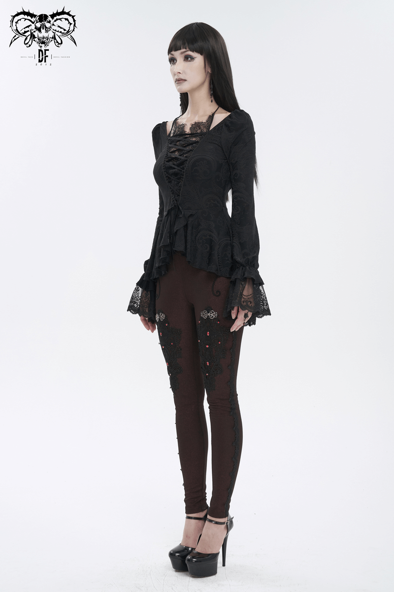 Vintage black top with lace-up front and flared lace sleeves paired with stylish leggings and high heels.