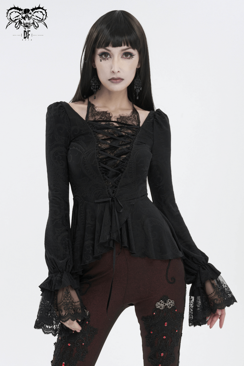 Vintage black irregular top with flared lace sleeves and lace-up front, perfect for a daring look.