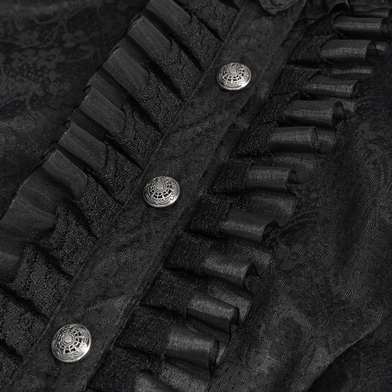 Close-up of a vintage black blouse with ornate buttons and ruffled detailing on the front, perfect for gothic style.