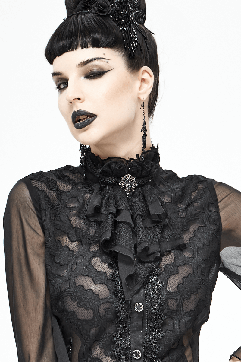 Gothic woman in black lace blouse with ruffled collar and statement brooch, showcasing alternative fashion style.