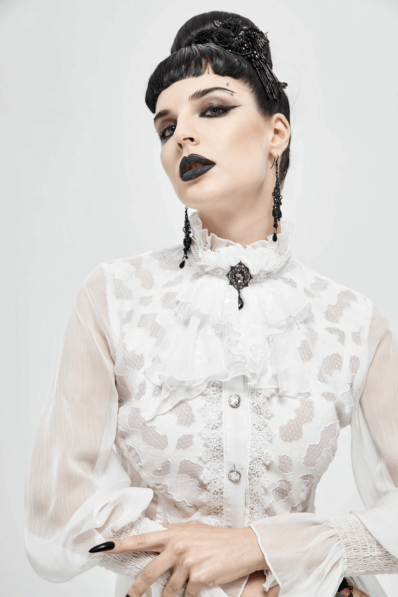 Vintage gothic woman in a white lace blouse, showcasing elegant alternative style jewelry and dark makeup.