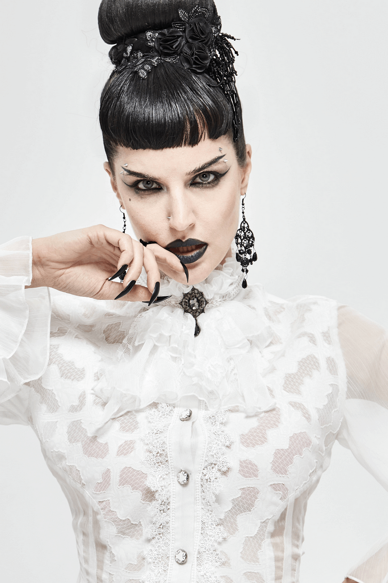 Gothic woman in white lace blouse with black hair and dark makeup, showcasing vintage style and elegance.