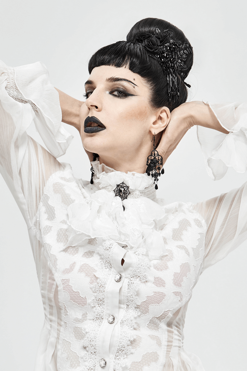 Model showcasing a vintage white lace tie with brooch, styled in gothic fashion with a dramatic pose.