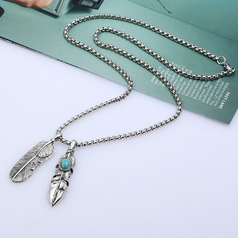 Vintage leaf long pendant necklace with feather details and turquoise accent, perfect for adding flair to any outfit.