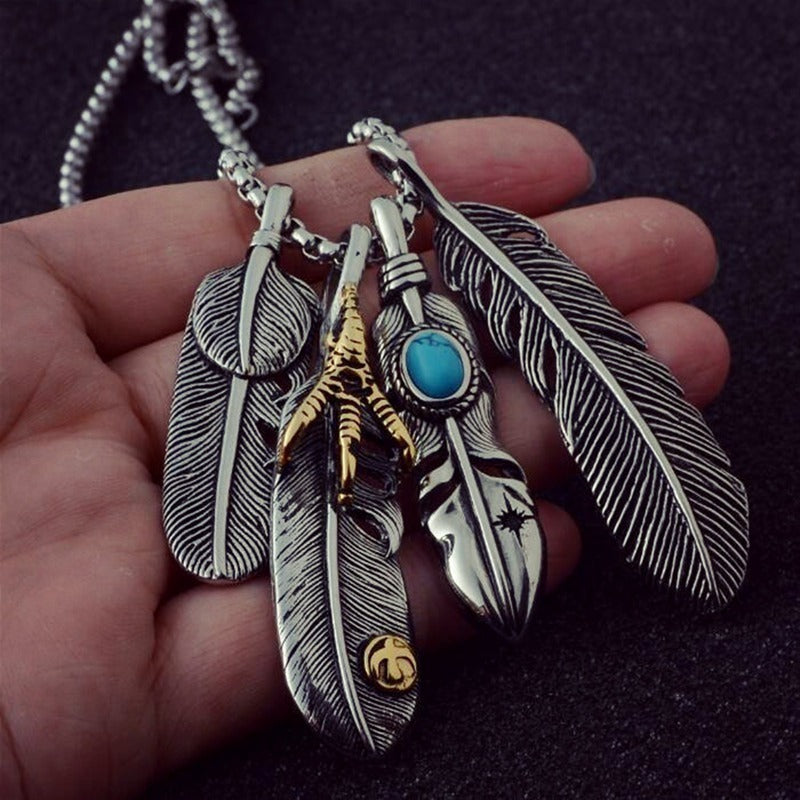 Vintage leaf long pendant necklaces featuring intricate feather details and a turquoise accent, perfect for bohemian style lovers.