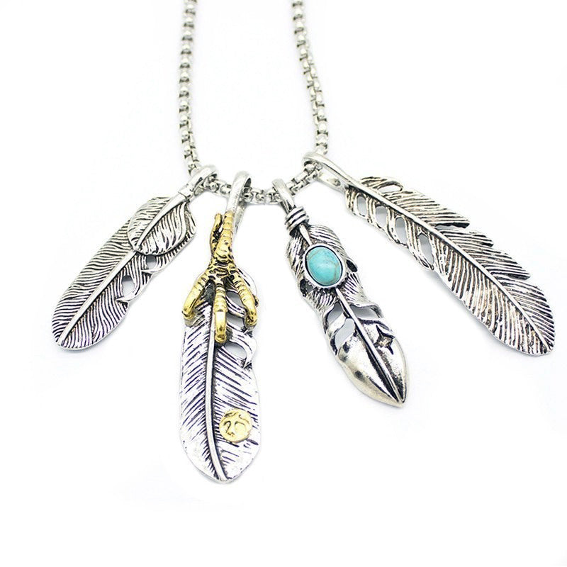 Vintage leaf pendant necklace with silver chains and assorted feather charms, perfect for stylish outfits.