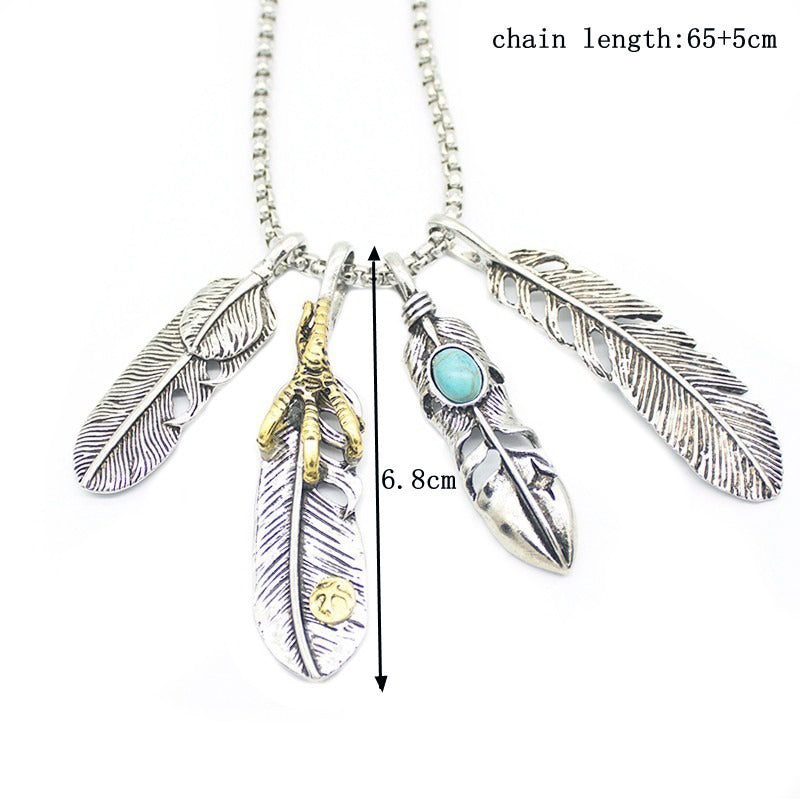 Vintage leaf pendant necklace with feather details on a silver chain, perfect for stylish outfits and accessories.
