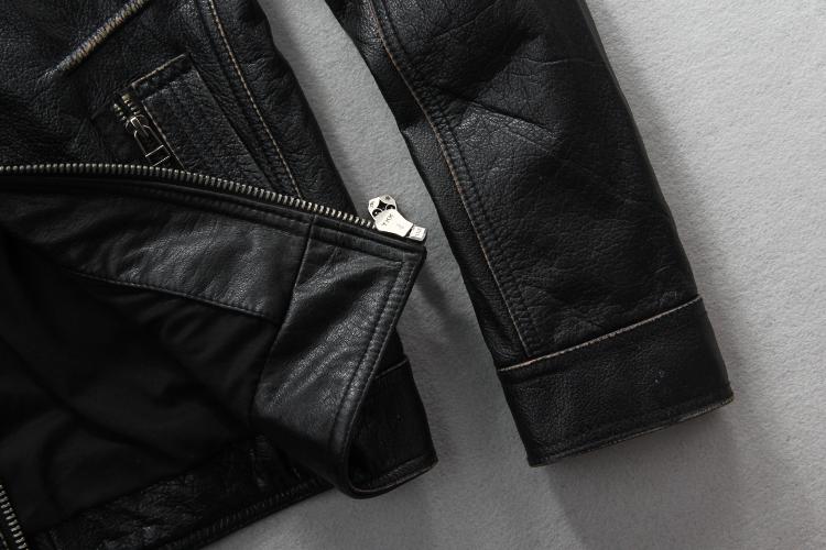 Close-up of vintage leather biker jacket showcasing zippers and textured details, perfect for rock style enthusiasts.