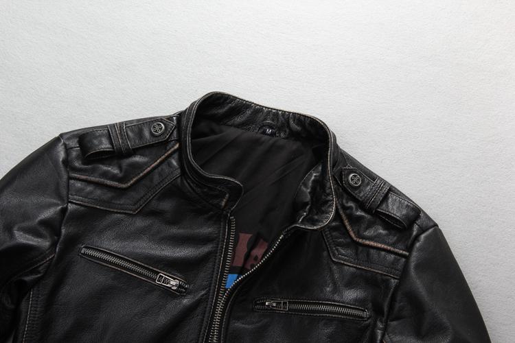 Close-up of a vintage black leather biker jacket with zippers and snap collar, showcasing rock style features.