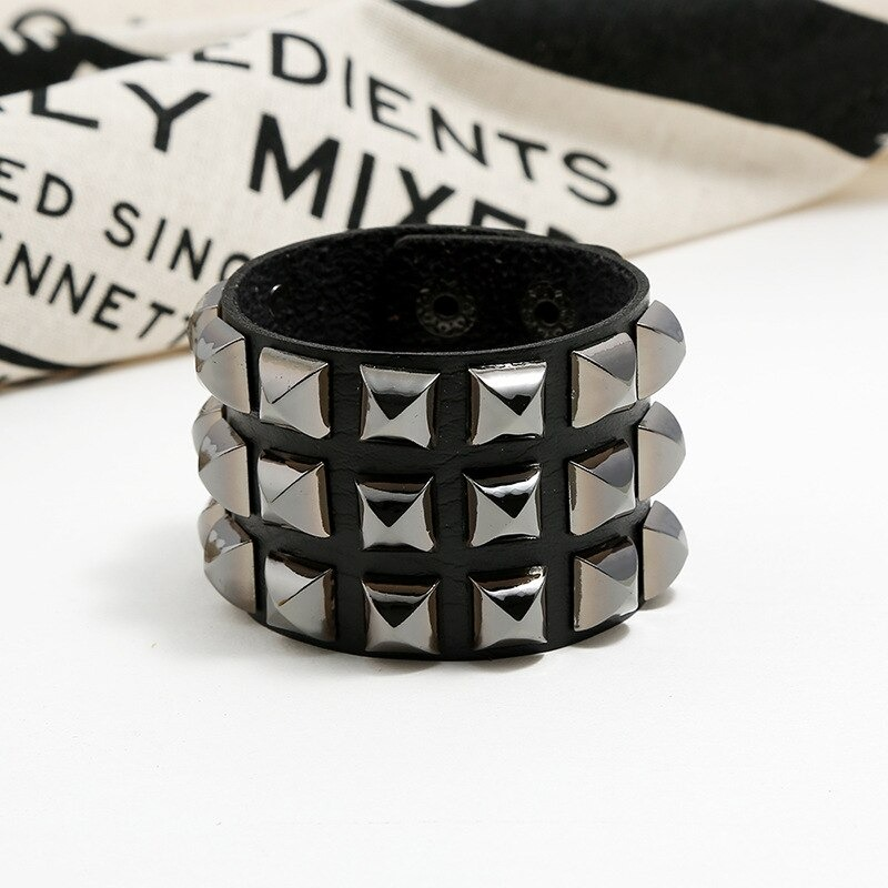 Vintage leather bracelet with metal spikes, perfect for punk rock style, unisex wide cuff accessory.