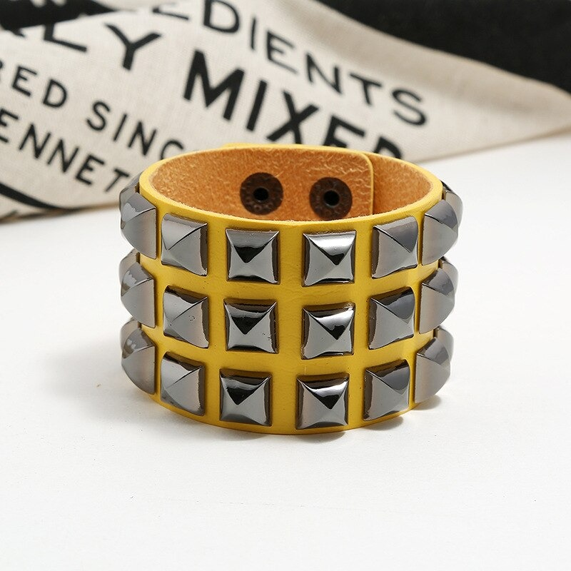 Vintage leather bracelet with spikes in punk rock style, unisex wide cuff accessory for men and women.