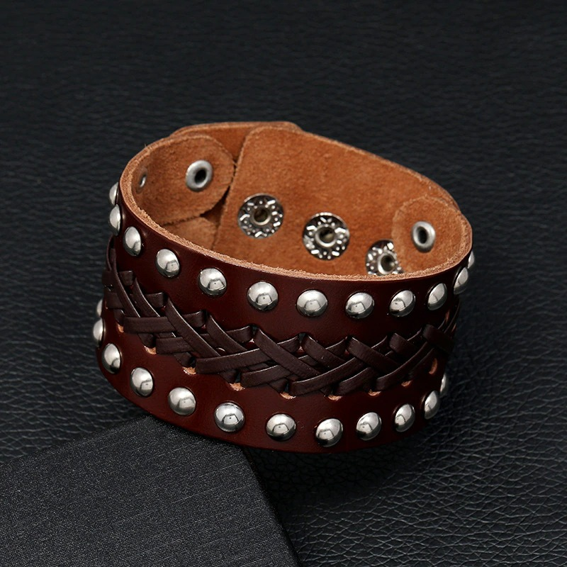 Wide vintage male leather bracelet with manual weave and silver rivets in punk-rock style.