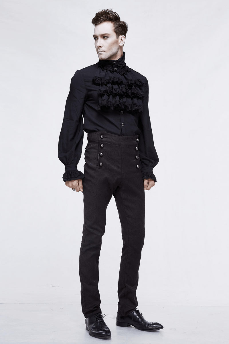 Stylish male model in vintage black slim high waist suit pants with designer buttons and a frilly black shirt.