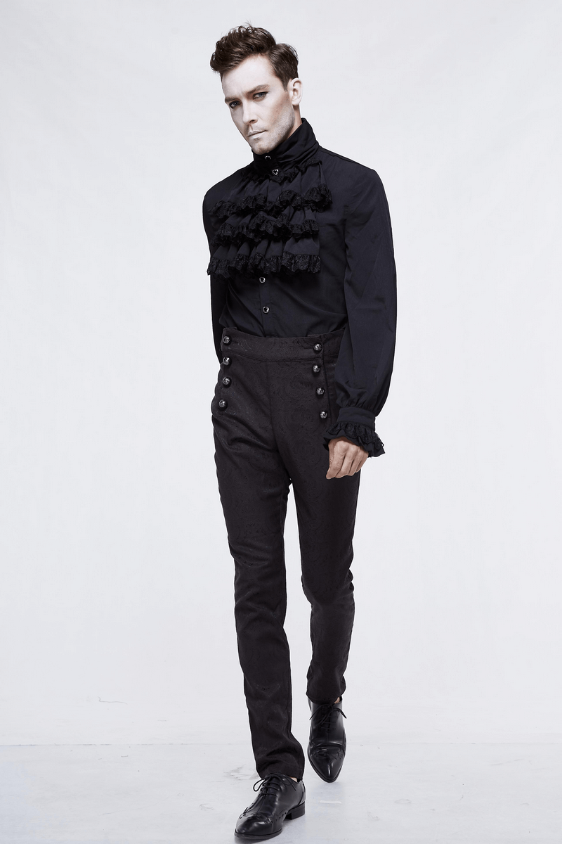 Stylish male model in vintage black slim high waist trousers with designer buttons and ruffled shirt.