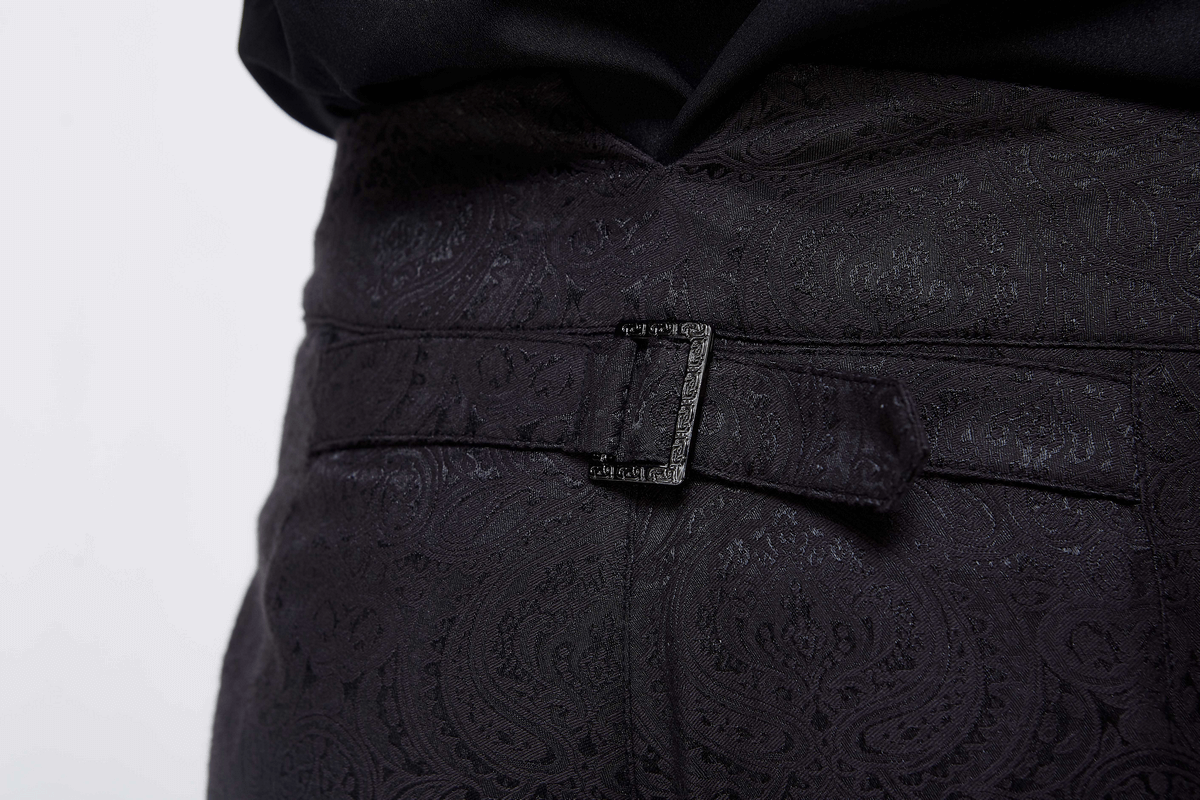 Close-up of vintage black slim pants featuring a decorative belt and elegant paisley texture.