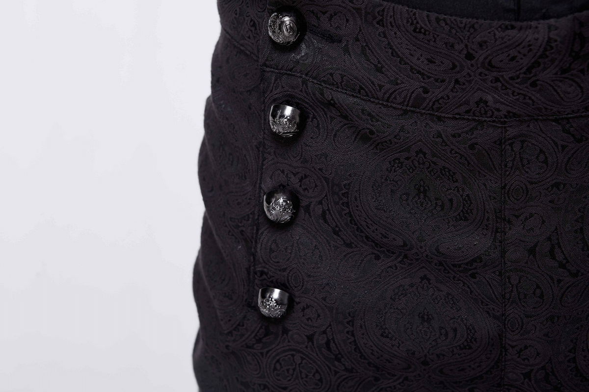 Close-up of vintage black suit pants featuring designer buttons and intricate paisley pattern.