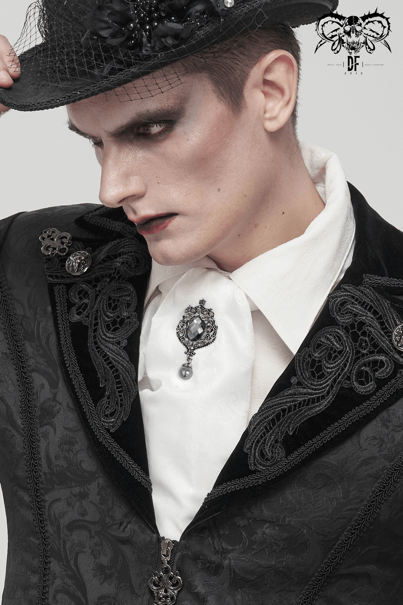 Gothic vintage male model showcasing a white tie with crystal brooch and elegant black attire.