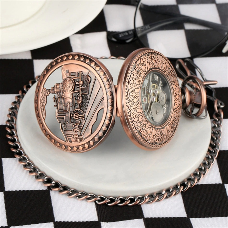 Vintage mechanical pocket watch with train design, bronze finish, and manual mechanism on a stylish plate.