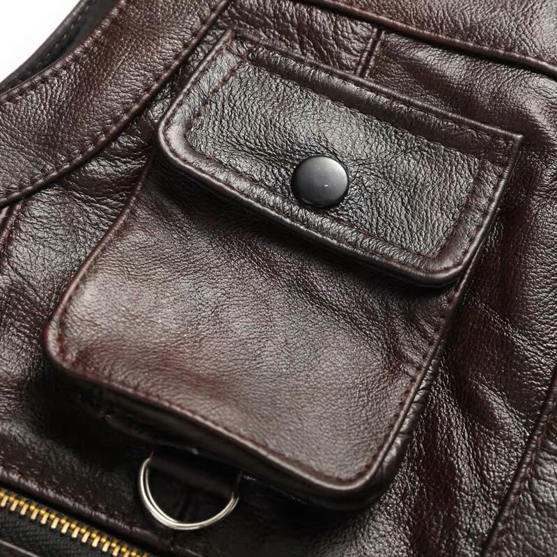 Close-up of a vintage men's biker leather vest pocket, showcasing genuine leather and rock style details.