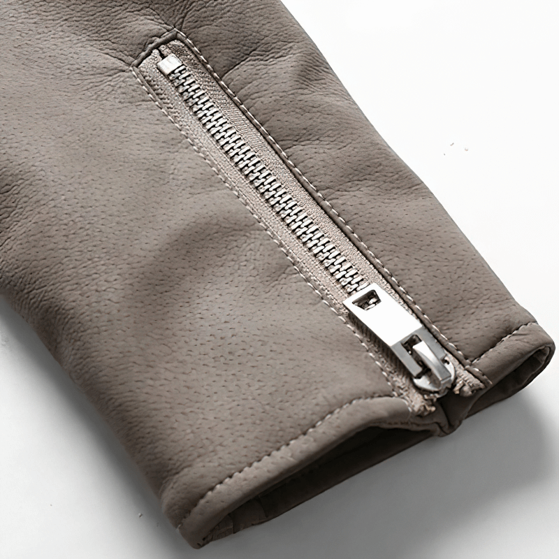 Close-up of a zipper on the sleeve of a vintage men's PU leather biker jacket.